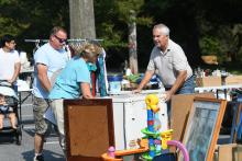 Tammy Andre and Rick arrange items at the Wesley Grove UMC Yard Sale